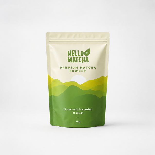 A 1kg stand-up pouch of Hello Matcha Premium Matcha Powder, featuring a cream-colored top half with green text and a green-to-yellow mountain graphic on the bottom half, set against a clean white background.